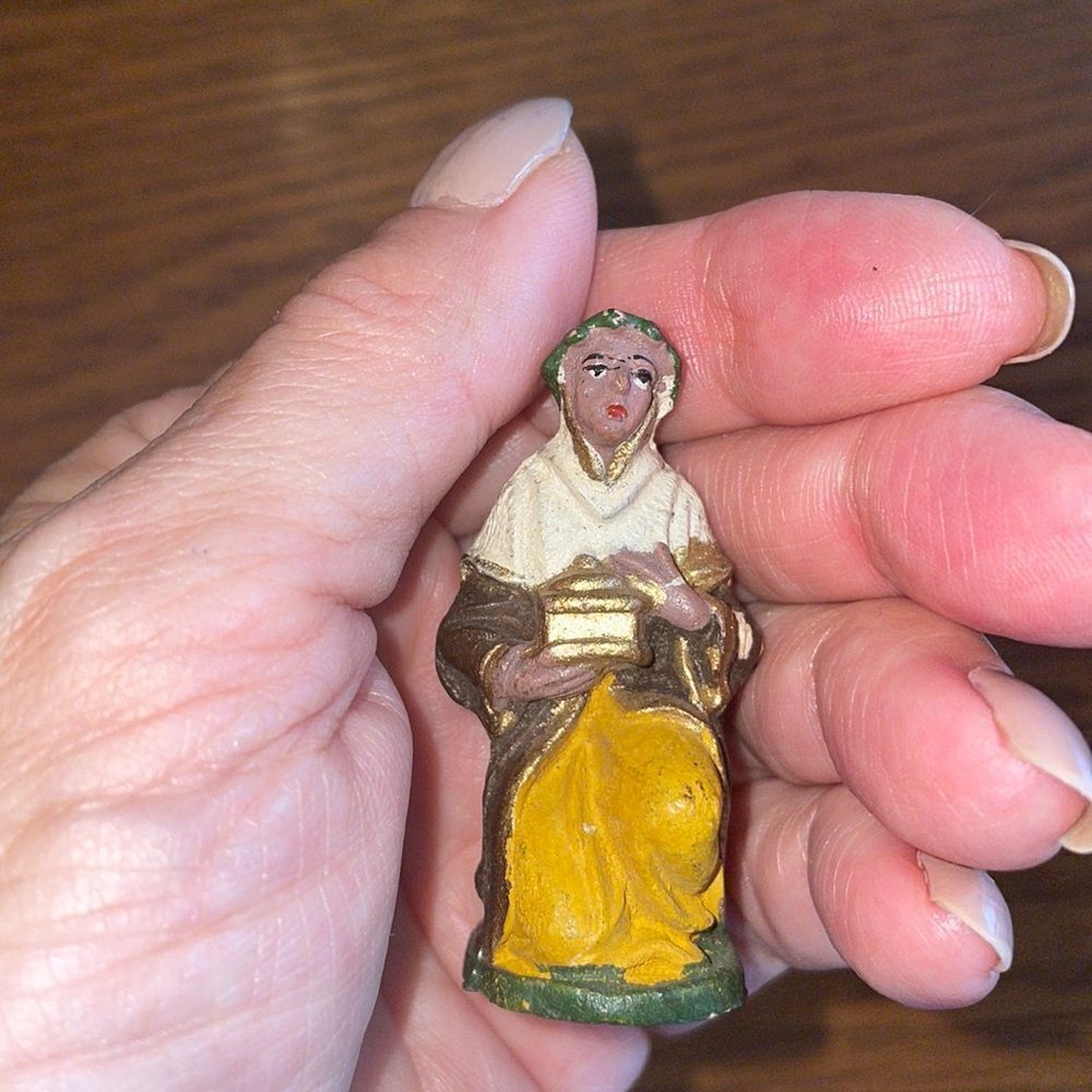 Small resin kneeling wise man from nativity scene holding a gold box